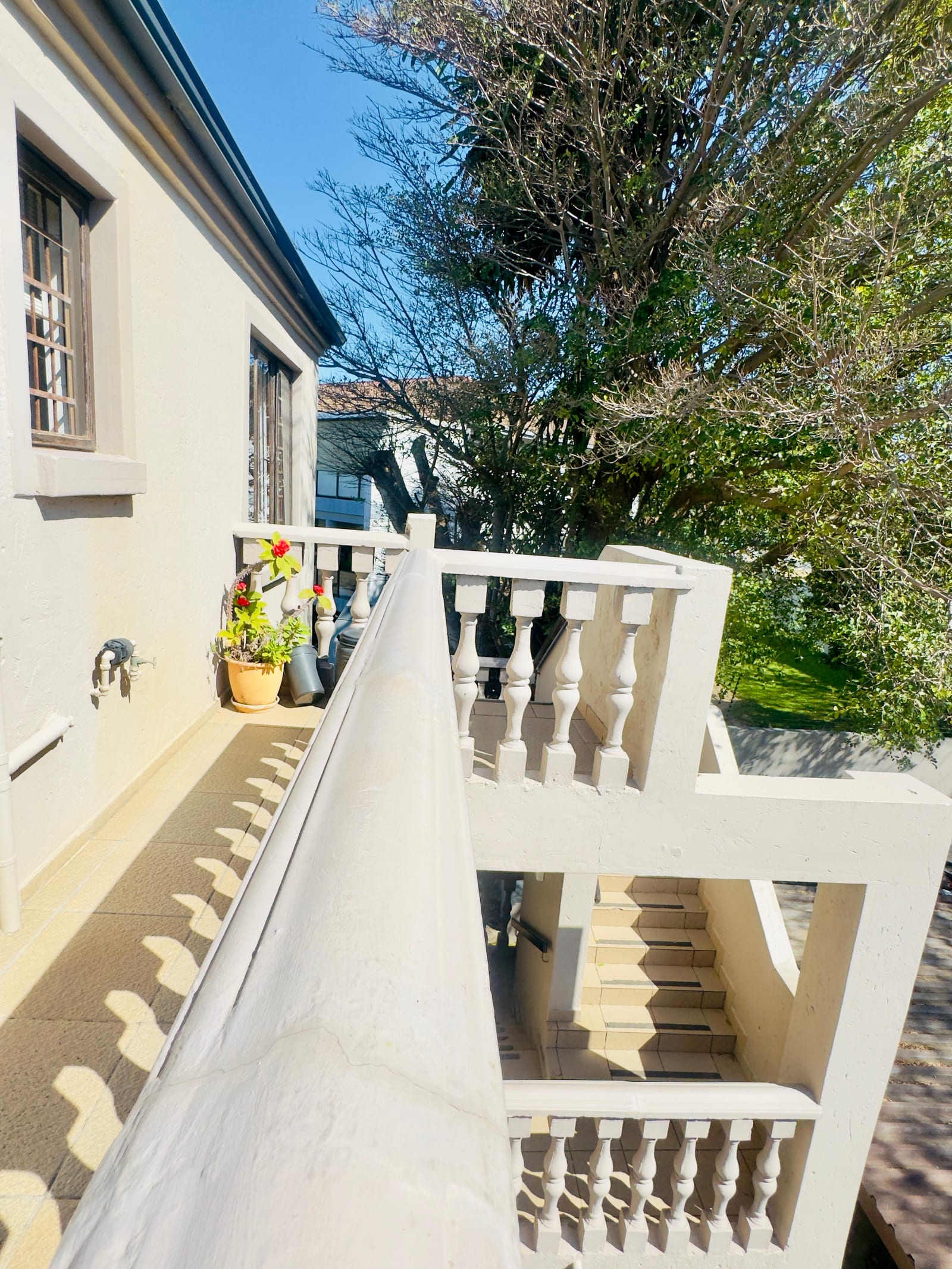 The building and its balustraded stairwell seen from the garden