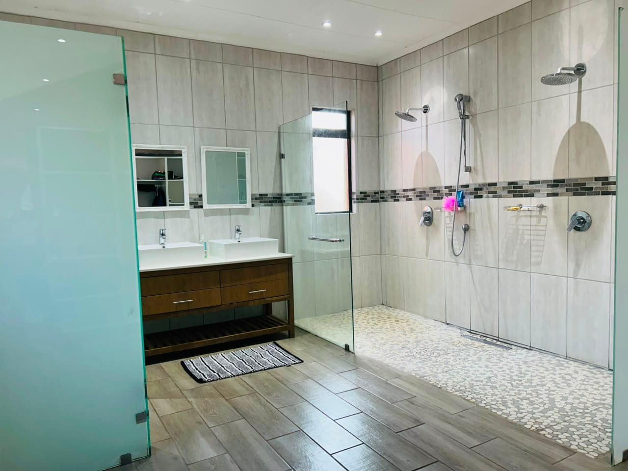 The main bathroom with twin basins and a double walk-in shower